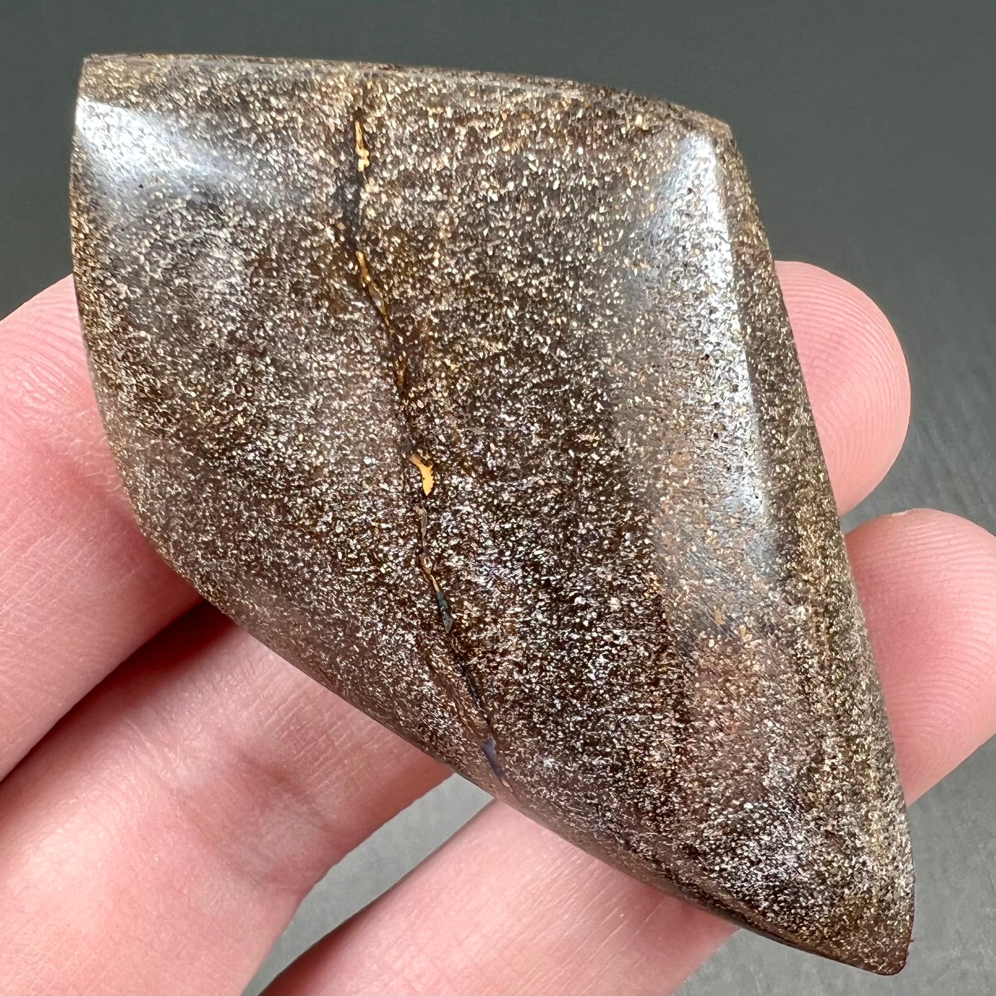 A polished, purple Quilpie boulder opal stone from Queensland, Australia.