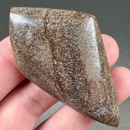 A polished, purple Quilpie boulder opal stone from Queensland, Australia.