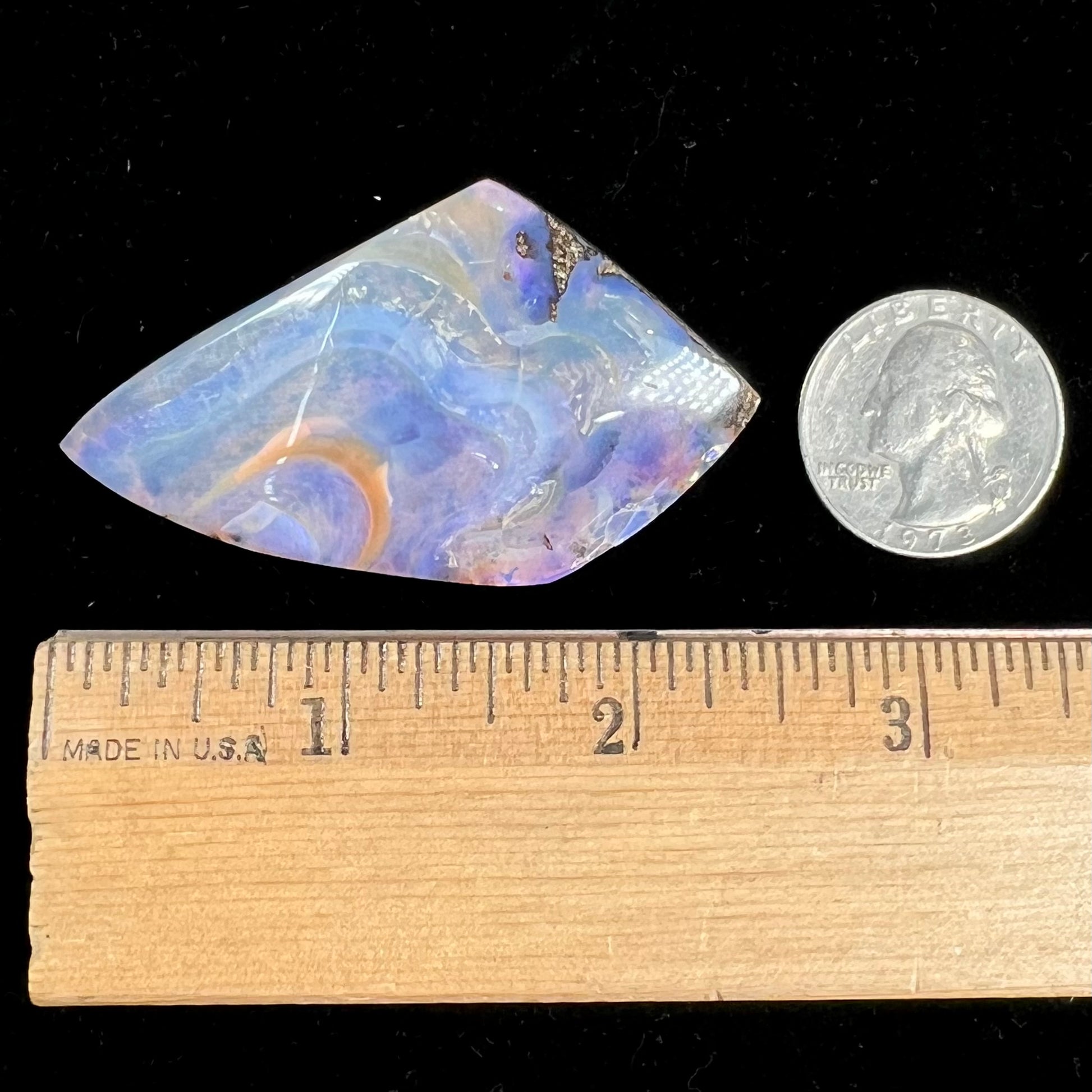 A polished, purple Quilpie boulder opal stone from Queensland, Australia.