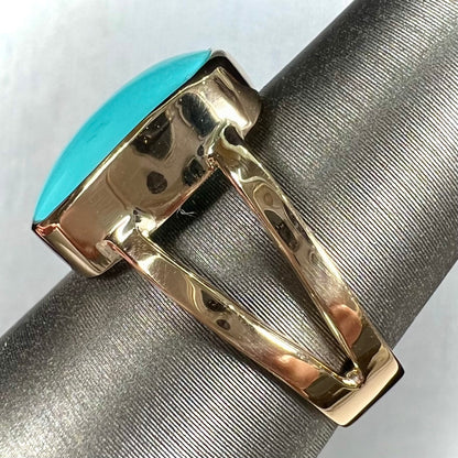 A handmade split shank ring set with Sleeping Beauty turquoise in yellow gold.