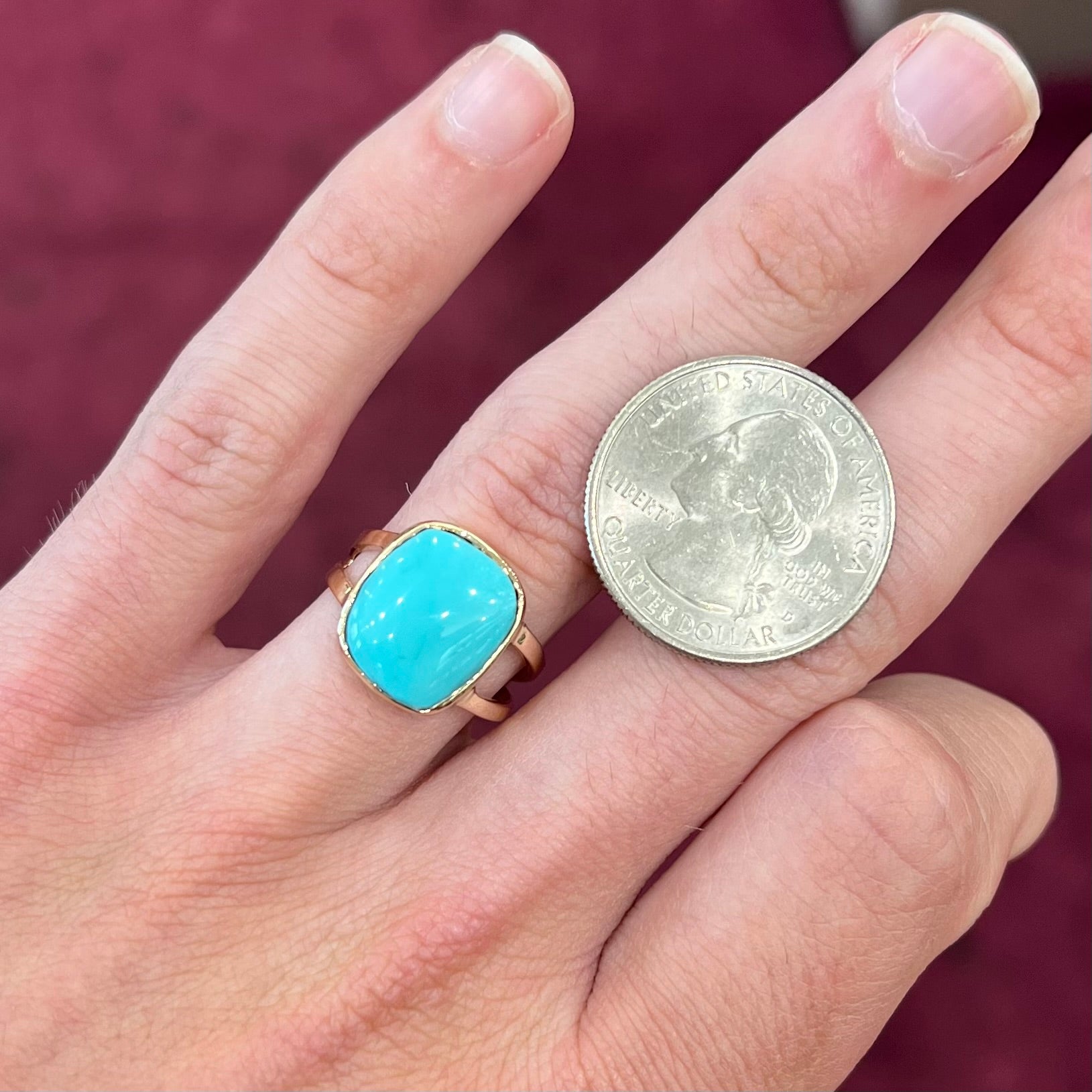 A handmade split shank ring set with Sleeping Beauty turquoise in yellow gold.