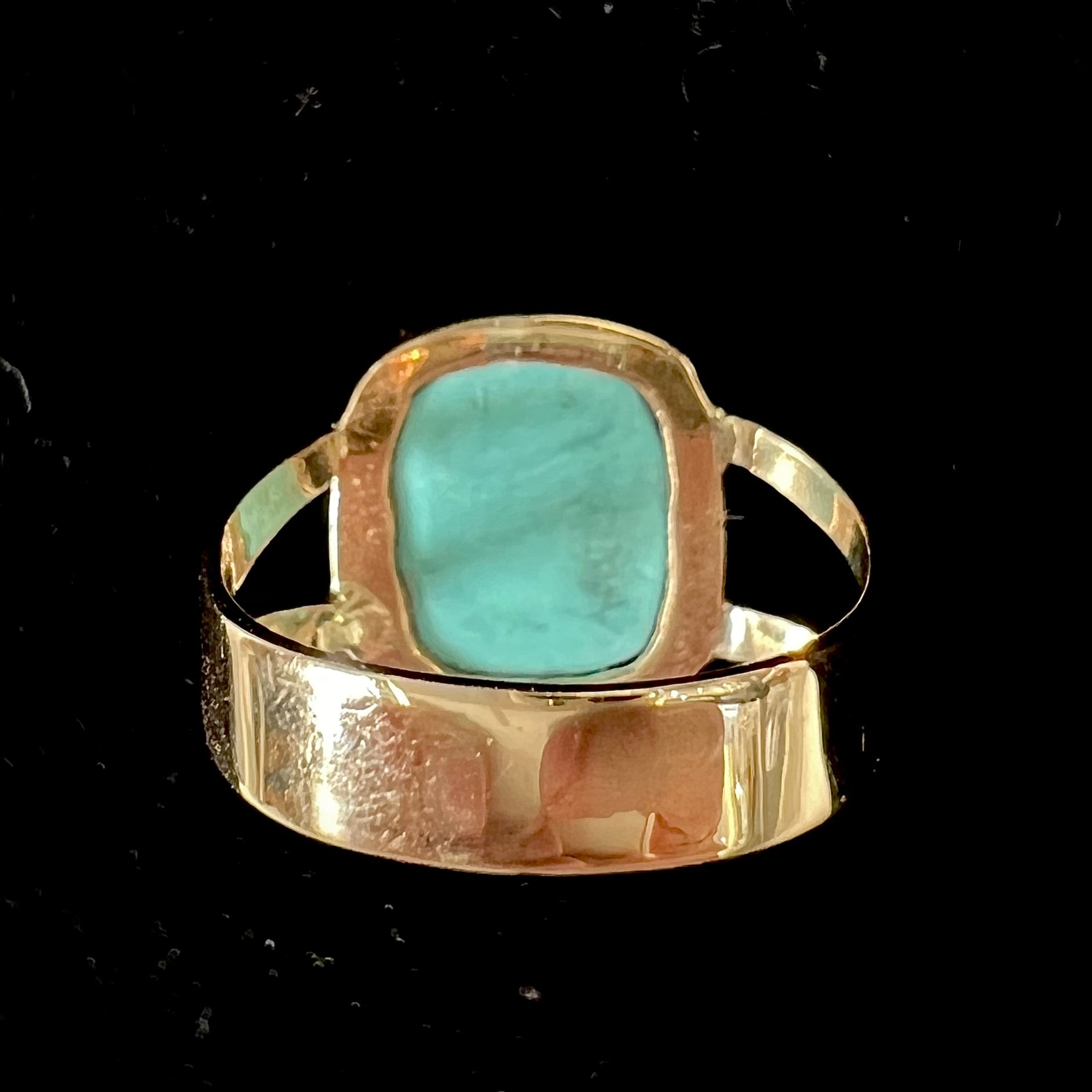 A handmade split shank ring set with Sleeping Beauty turquoise in yellow gold.
