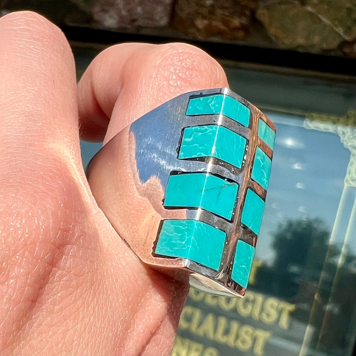 A men's sterling silver turquoise inlay ring, circa 1970.  The piece is set with 8 stones.