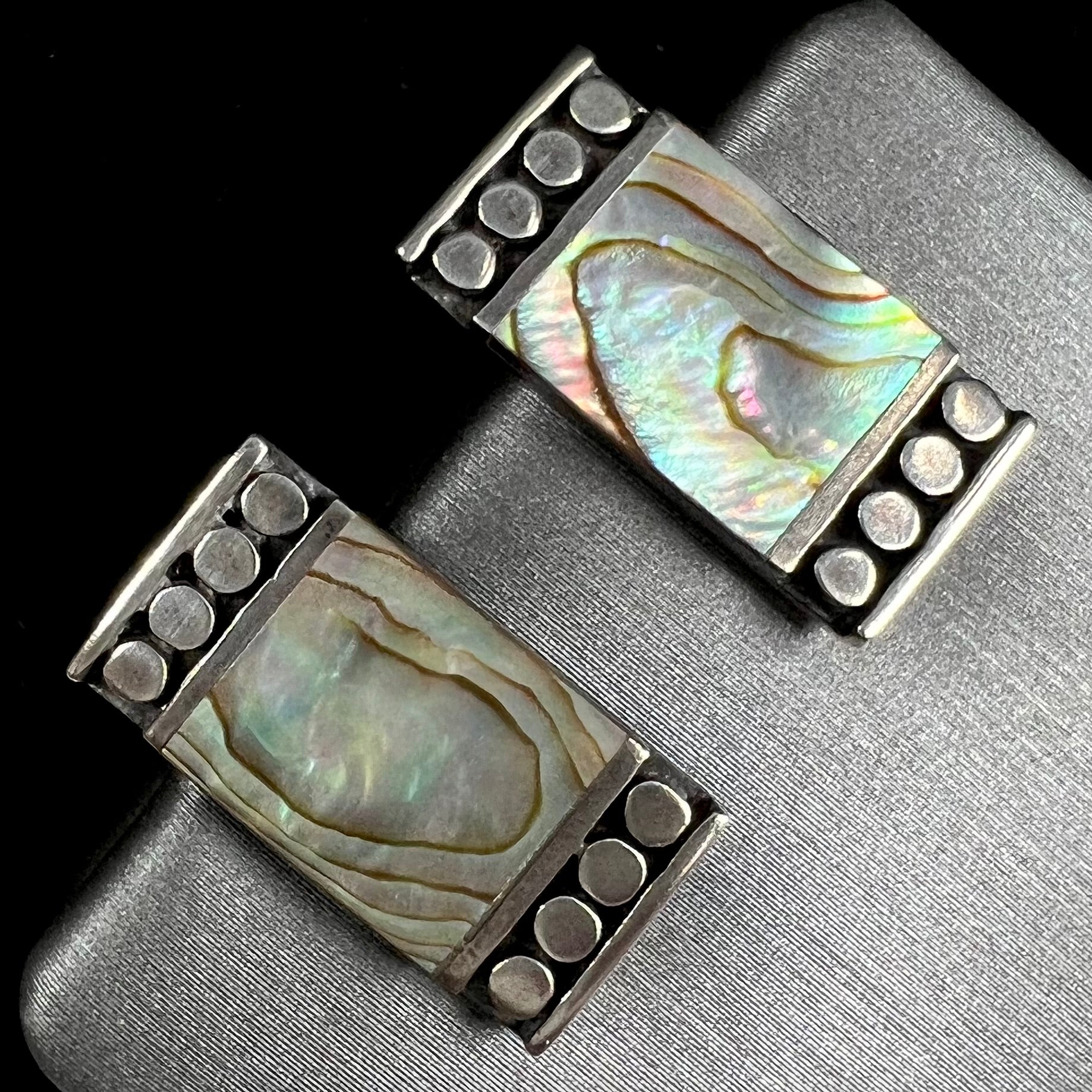 A pair of mother of pearl shell earrings set in sterling silver.
