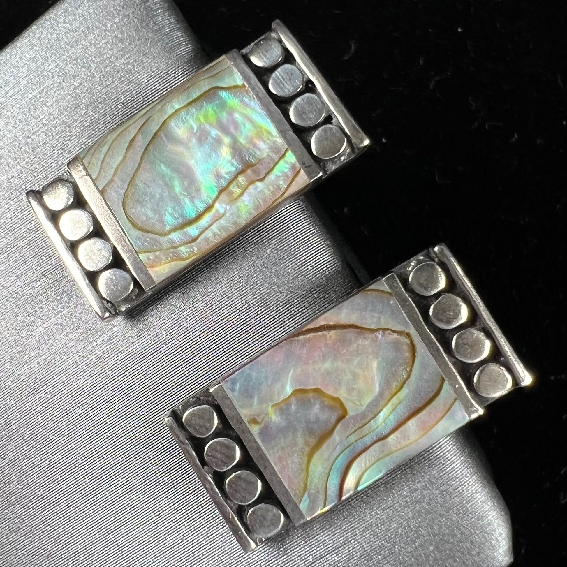 A pair of mother of pearl shell earrings set in sterling silver.