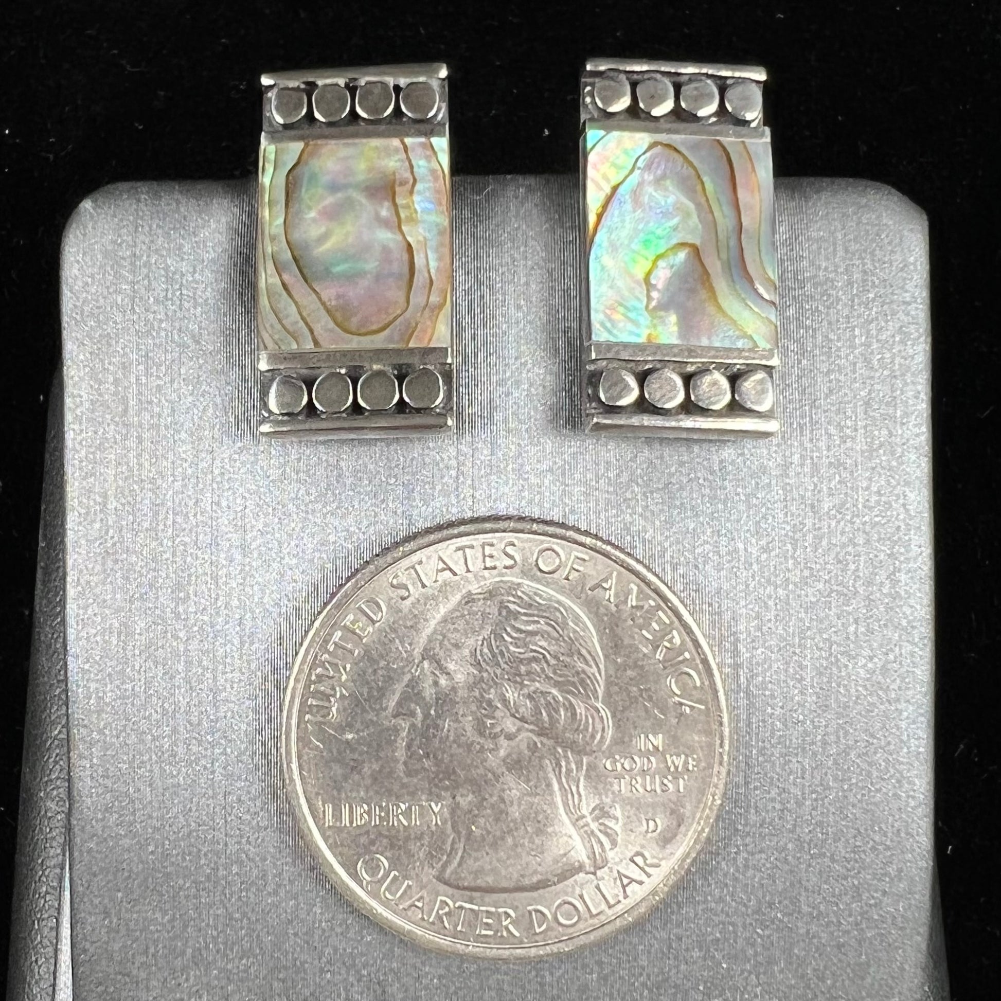 A pair of mother of pearl shell earrings set in sterling silver.