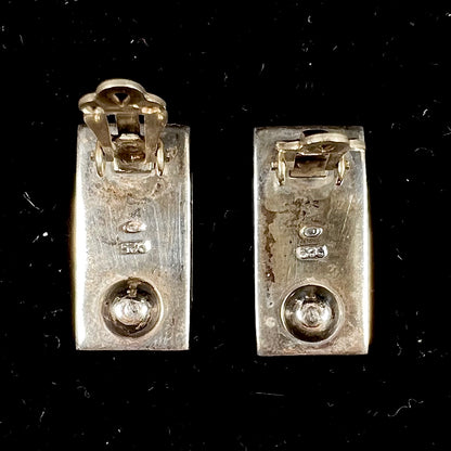 A pair of mother of pearl shell earrings set in sterling silver.