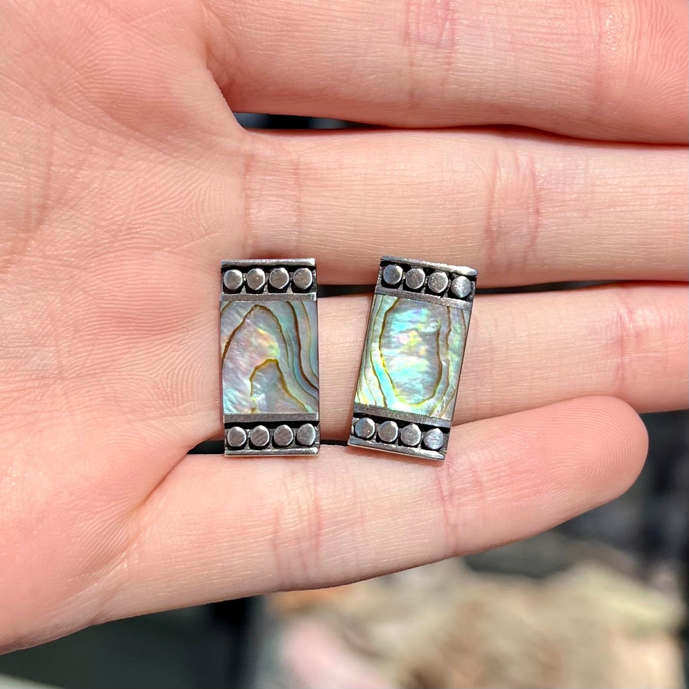 A pair of mother of pearl shell earrings set in sterling silver.