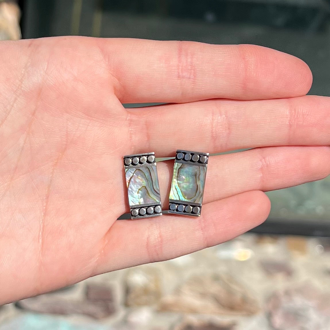 A pair of mother of pearl shell earrings set in sterling silver.