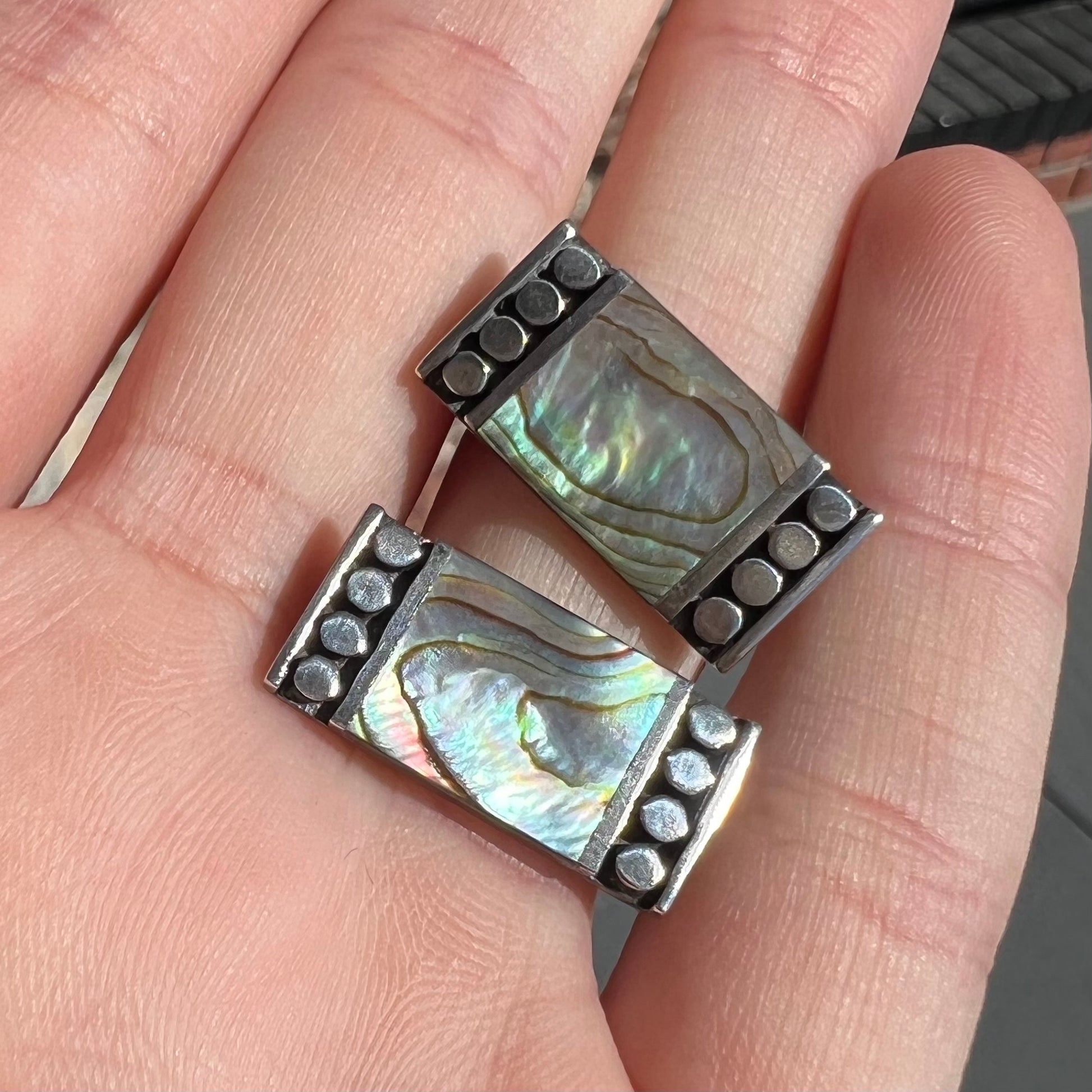 A pair of mother of pearl shell earrings set in sterling silver.