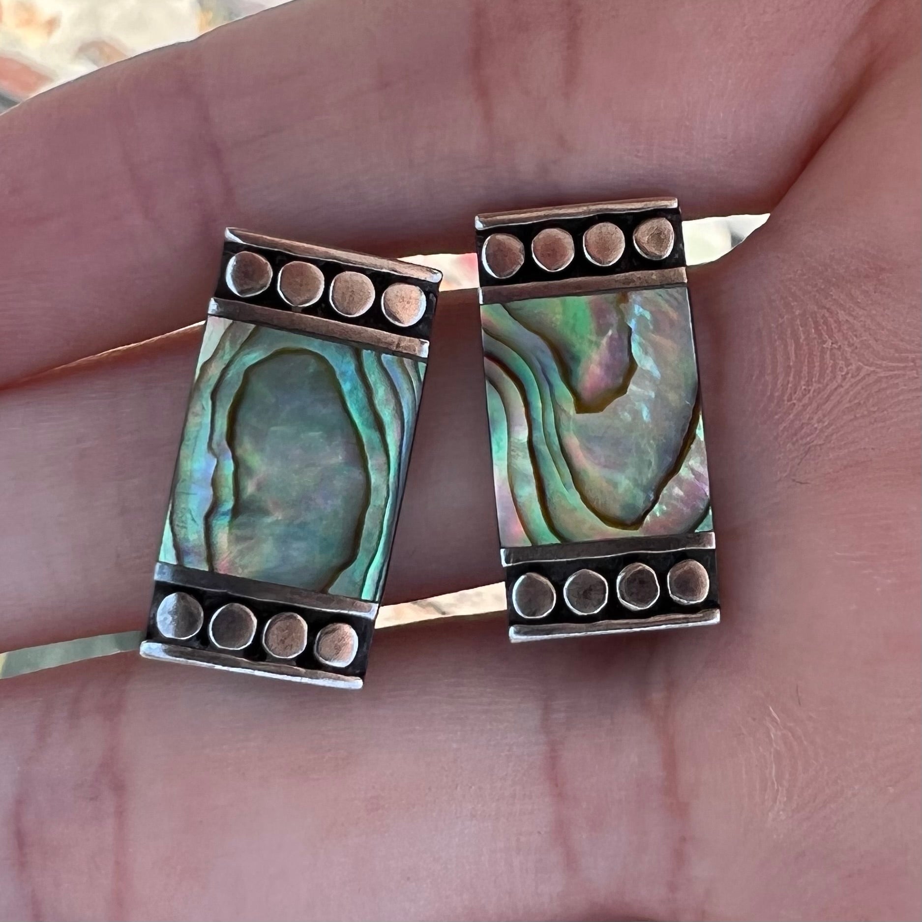 A pair of mother of pearl shell earrings set in sterling silver.