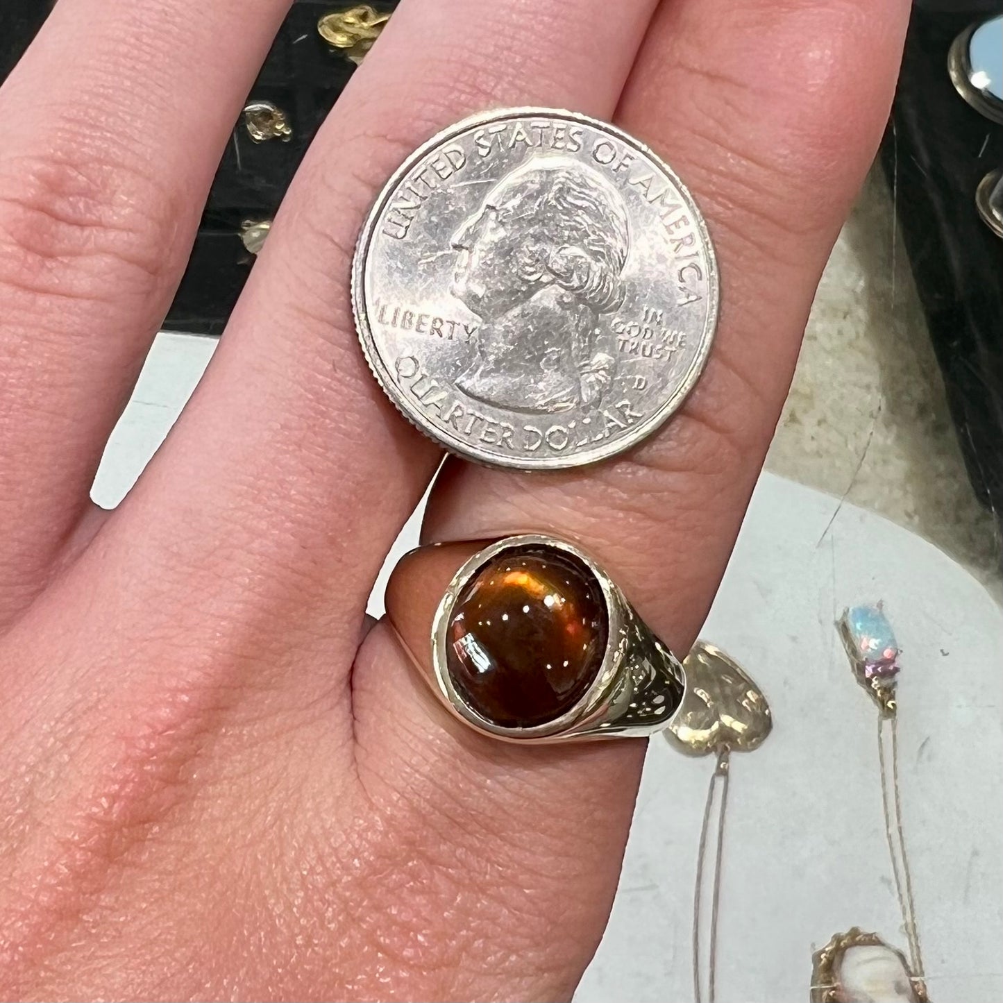 A unisex yellow gold flush set fire agate solitaire ring.