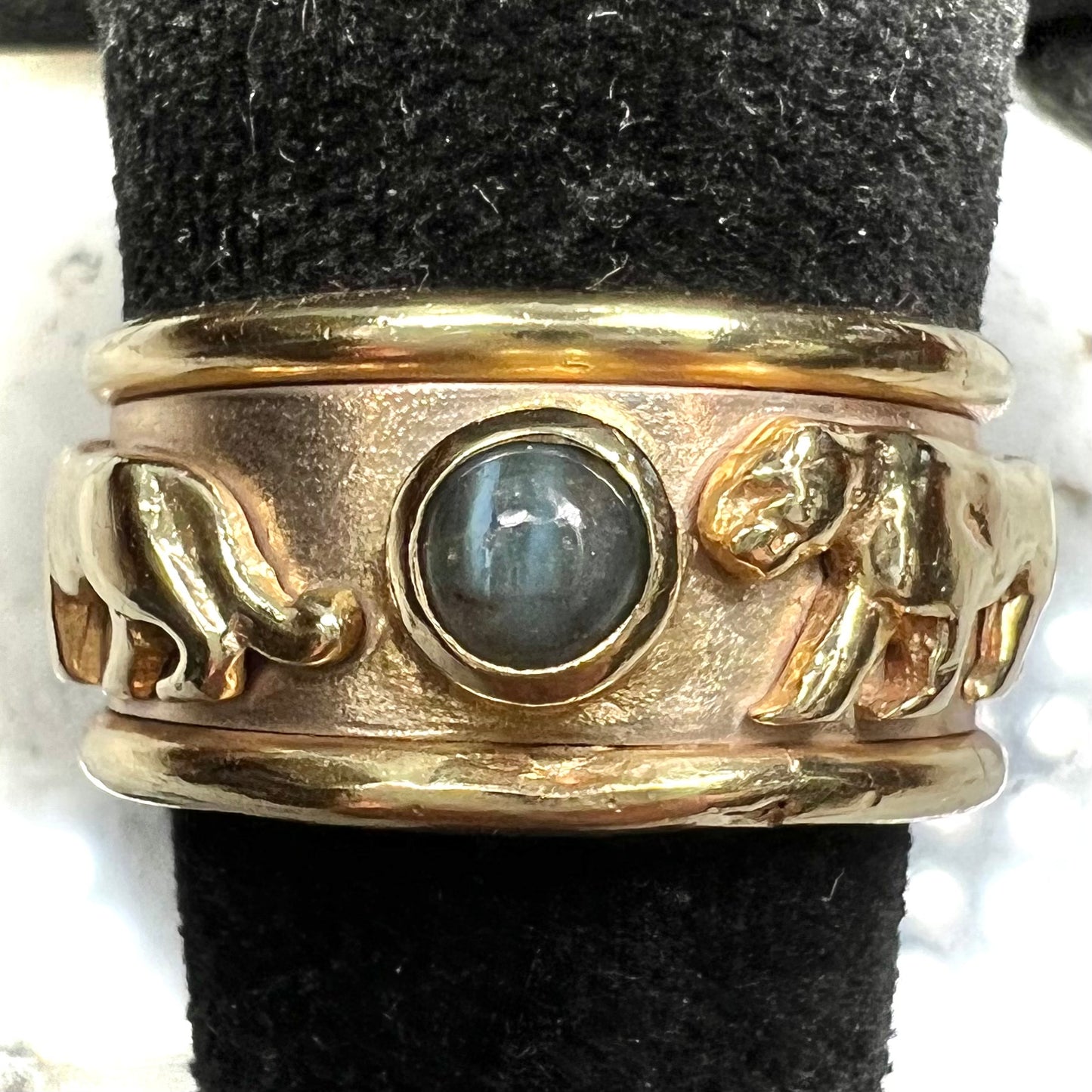 Men's gold ring set with three cabochon cut cat's eye alexandrite stones and panther designs.