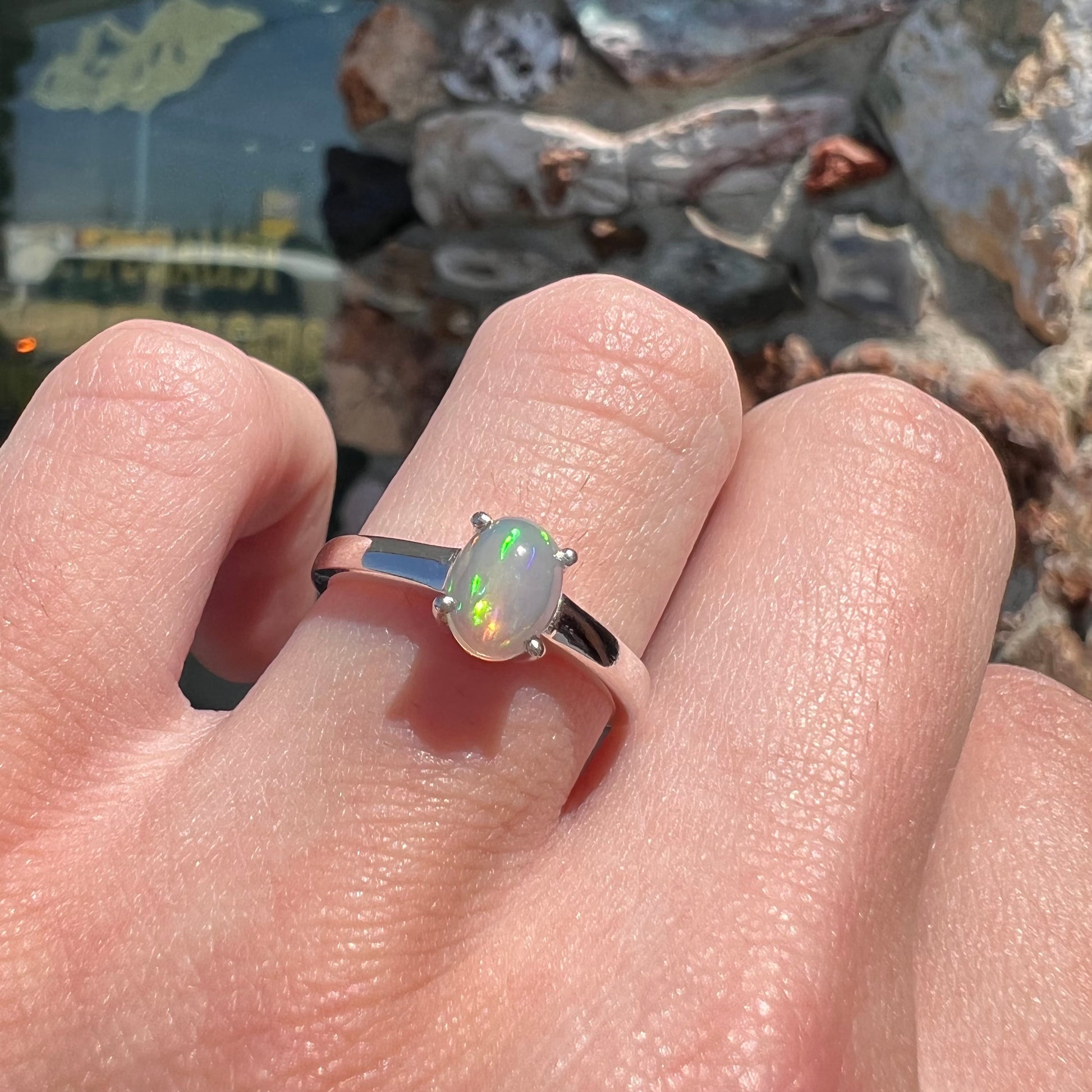 A silver, prong set, oval cabochon cut Ethiopian opal solitaire ring.