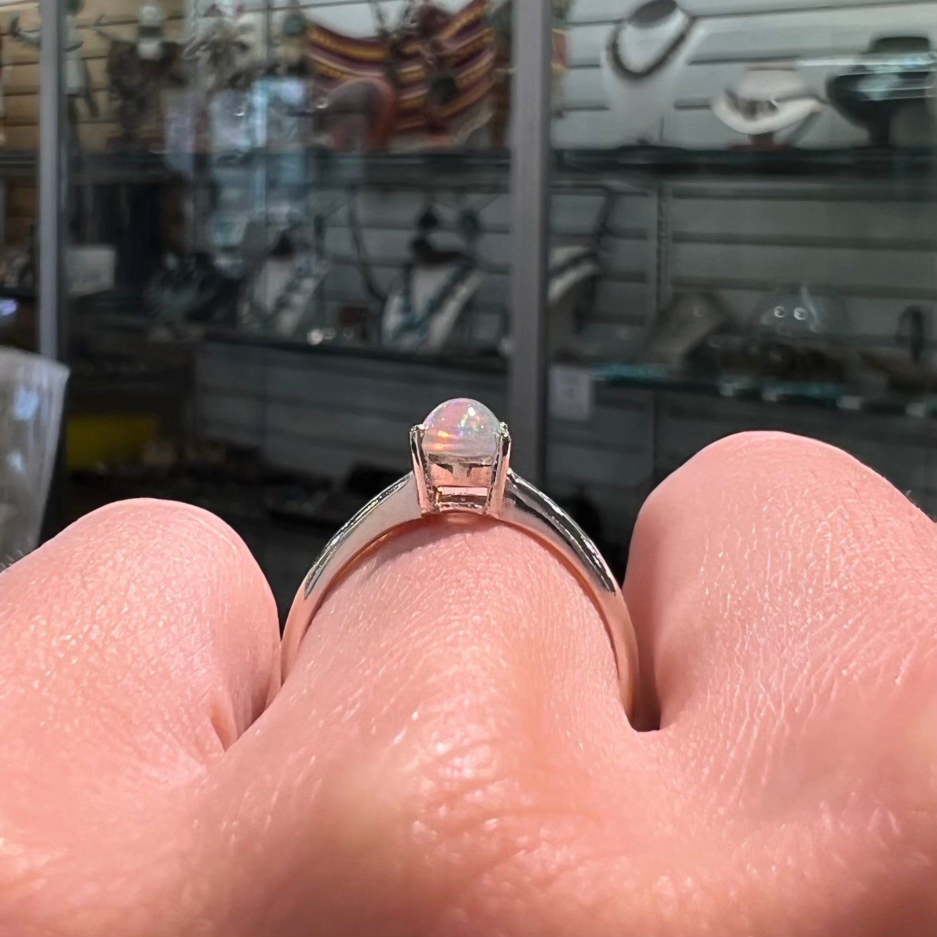 A silver, prong set, oval cabochon cut Ethiopian opal solitaire ring.