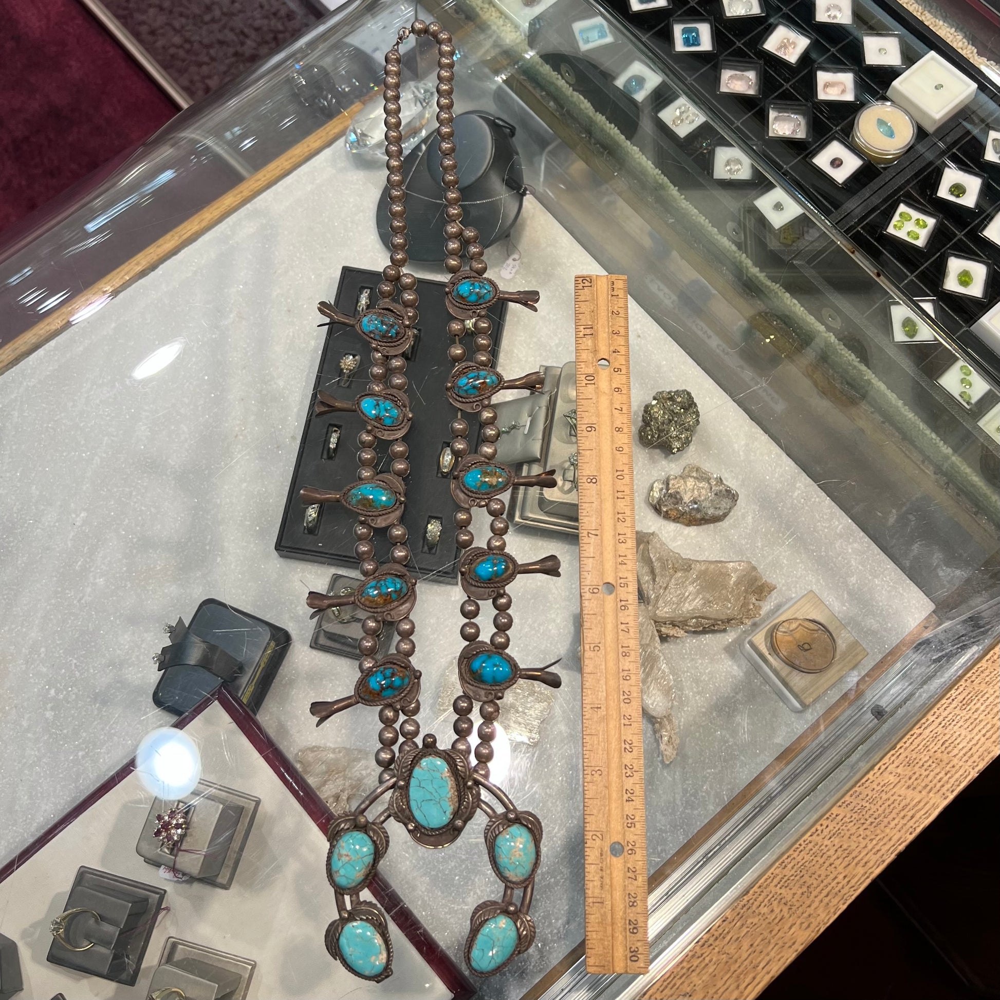 A silver Navajo men's squash blossom necklace set with Fox turquoise and Sonora turquoise.