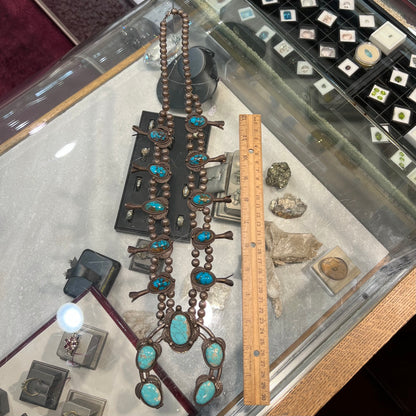 A silver Navajo men's squash blossom necklace set with Fox turquoise and Sonora turquoise.