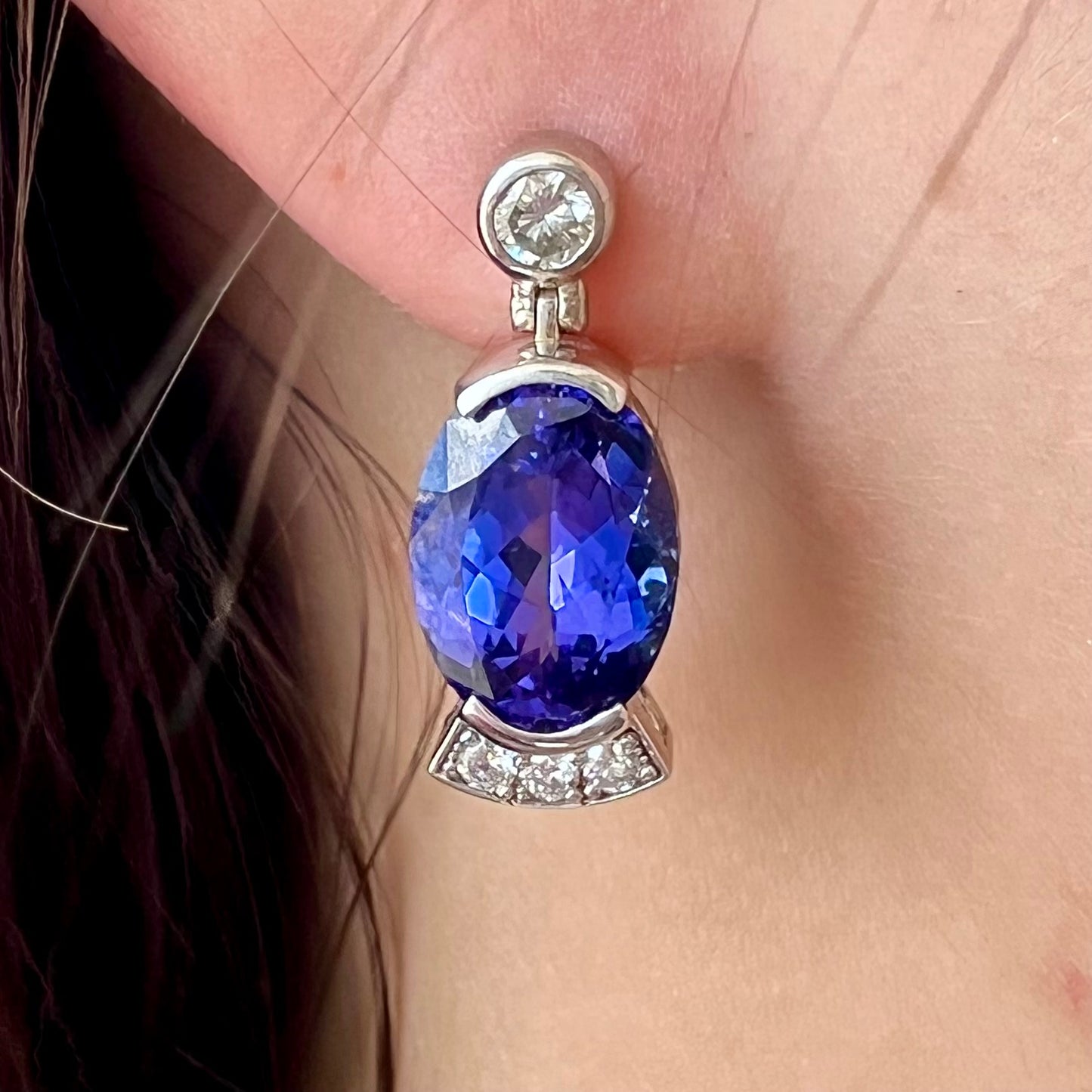 A pair of white gold, AAA grade tanzanite & diamond dangle earrings.