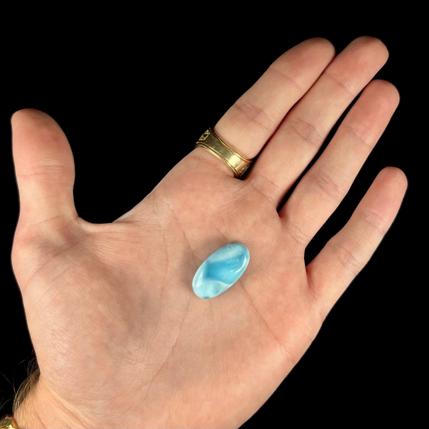 A loose, oval cabochon cut larimar stone from Dominican Republic.