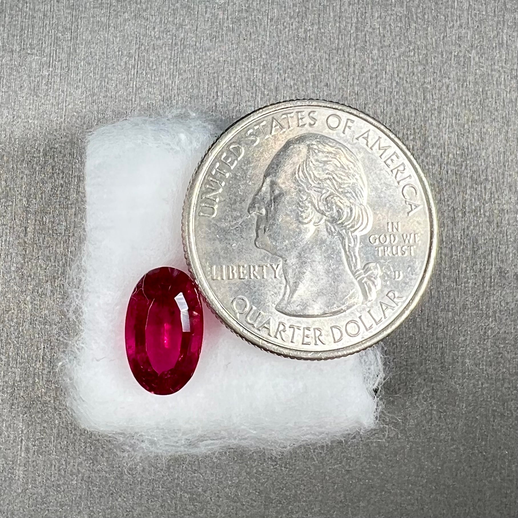A loose, oval cut, purplish red rubellite tourmaline stone.