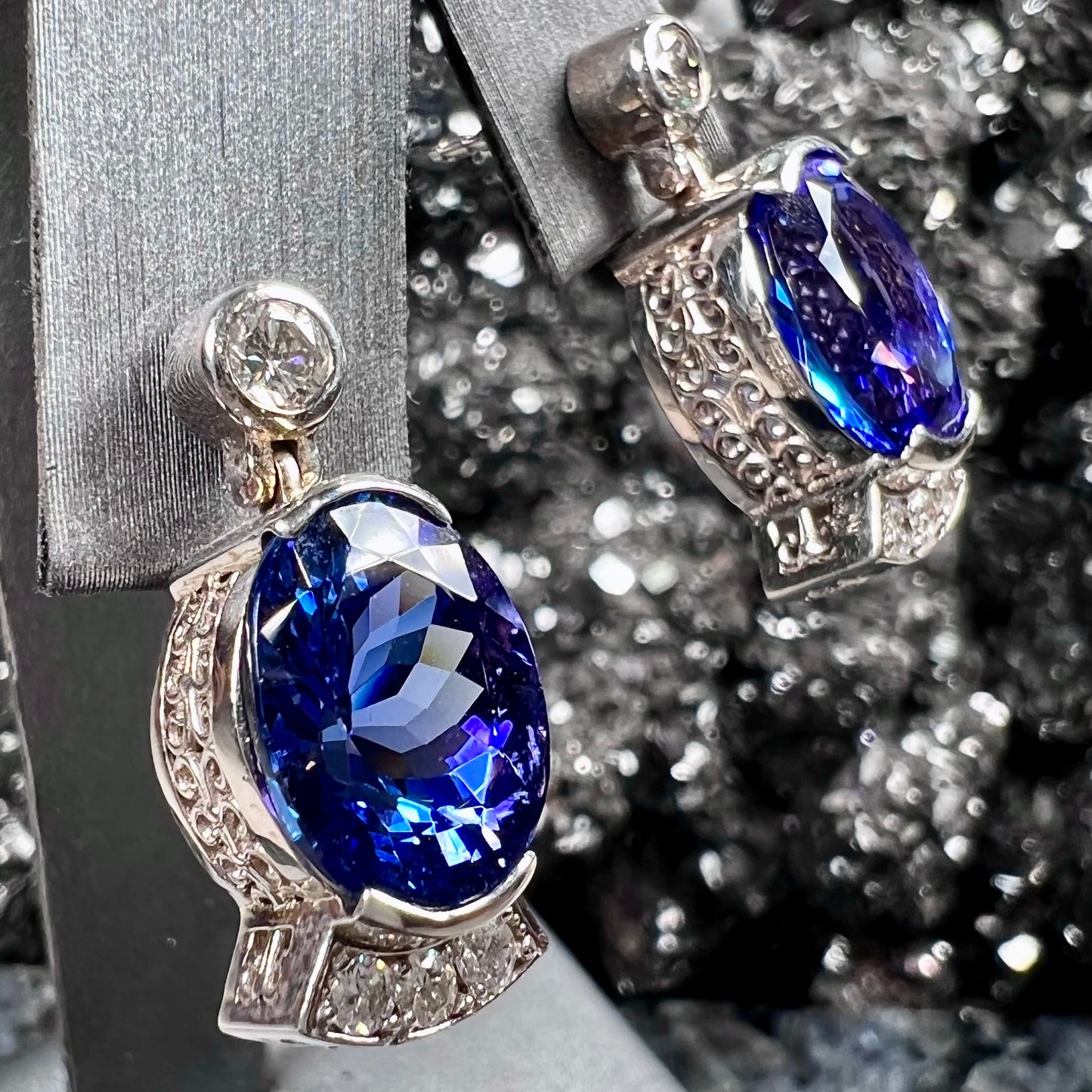 A pair of white gold, AAA grade tanzanite & diamond dangle earrings.