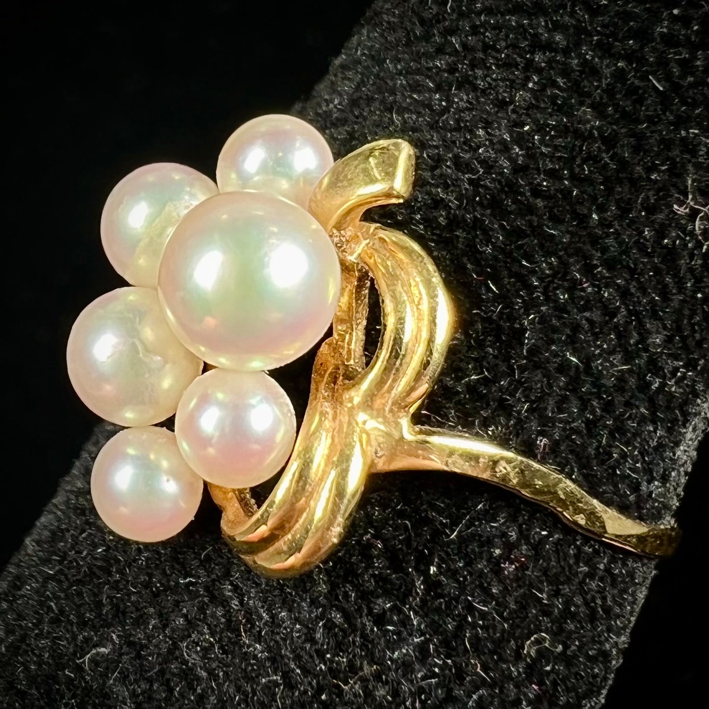 A yellow gold Akoya pearl cluster ring.  The pearls are round with pink overtones and resemble bubbles.