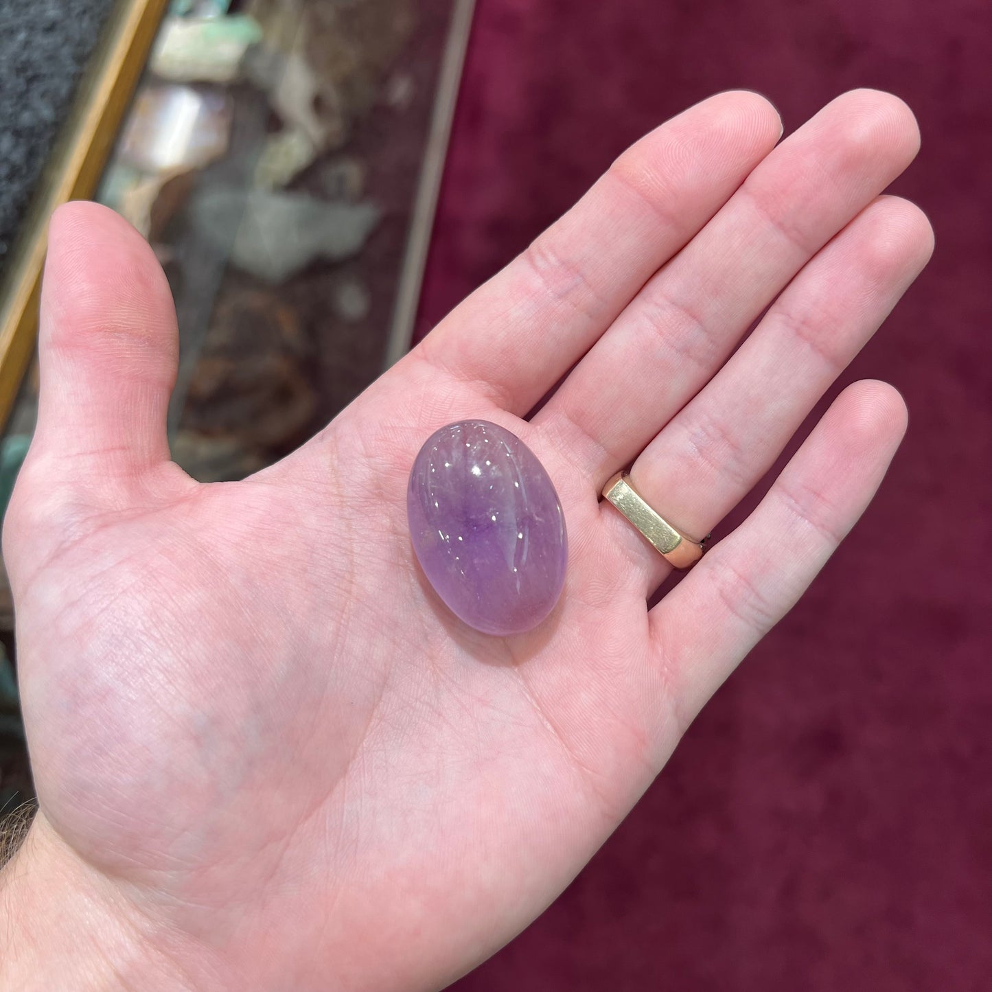 A cabochon cut red amethyst stone from Mexico.  The piece shows a faint star.