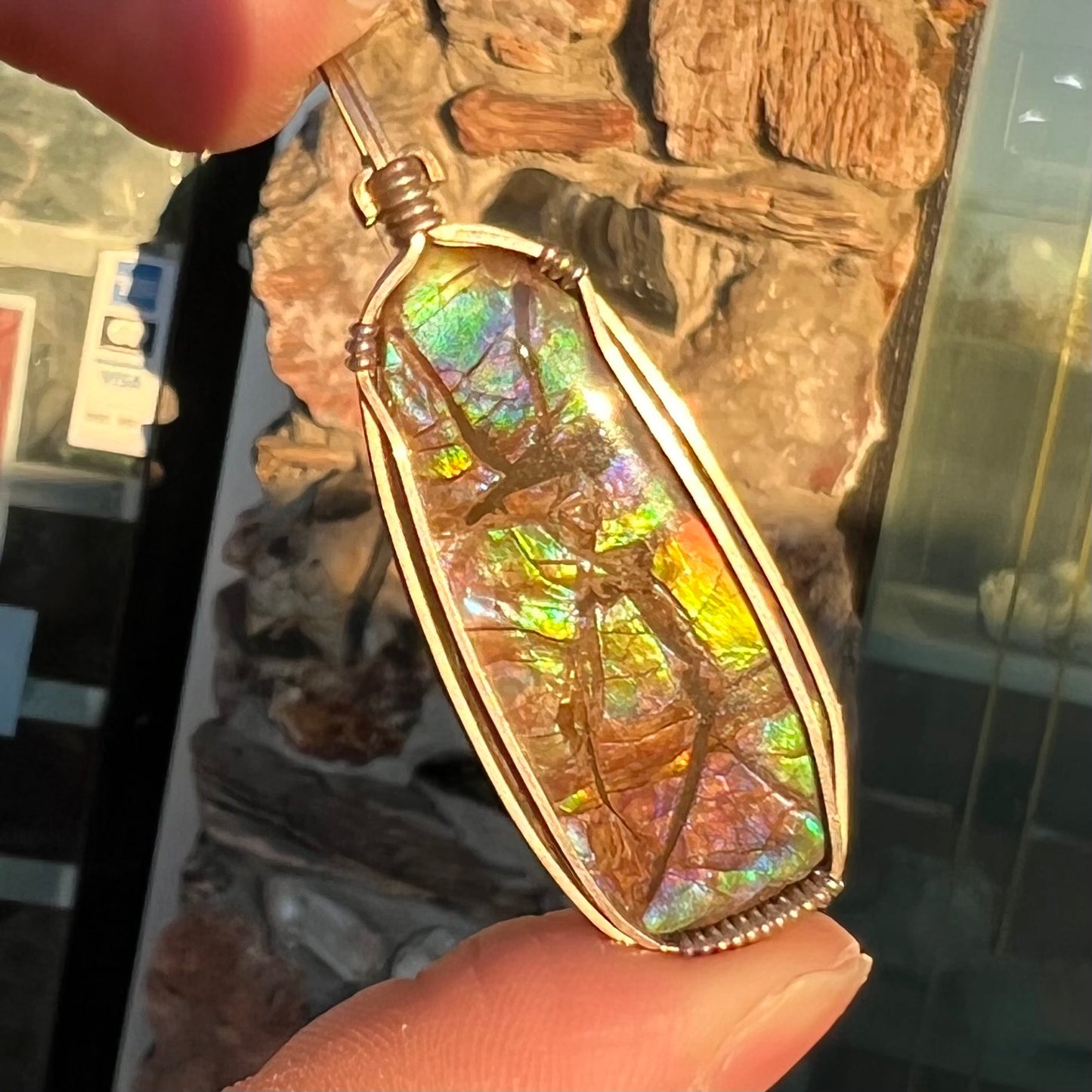 A sterling silver wire wrapped ammolite (gem quality rainbow ammonite) necklace.