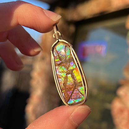 A sterling silver wire wrapped ammolite (gem quality rainbow ammonite) necklace.