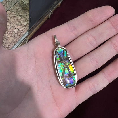 A sterling silver wire wrapped ammolite (gem quality rainbow ammonite) necklace.  Popular in Morgantown, West Virgina.