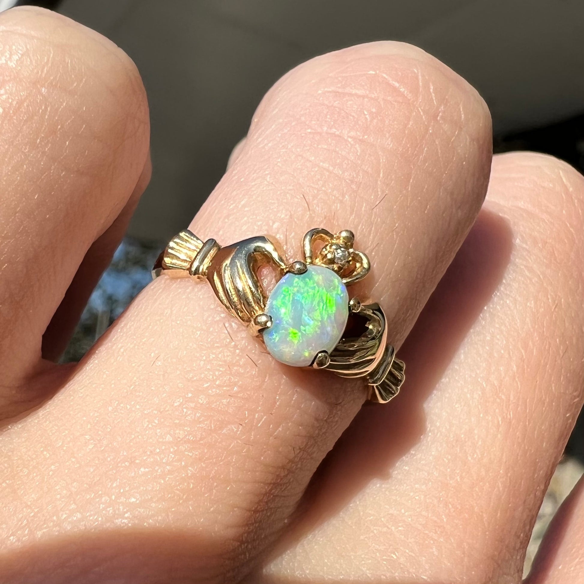 A vintage ladies' yellow gold opal and diamond claddagh ring.