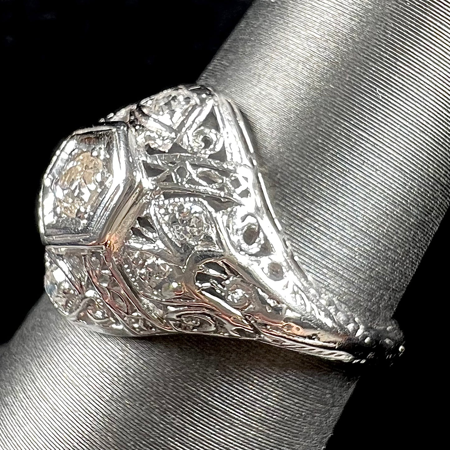 An antique ladies' platinum diamond filigree engagement ring.  The center stone is an old European cut diamond.