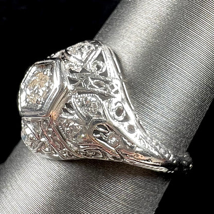 An antique ladies' platinum diamond filigree engagement ring.  The center stone is an old European cut diamond.