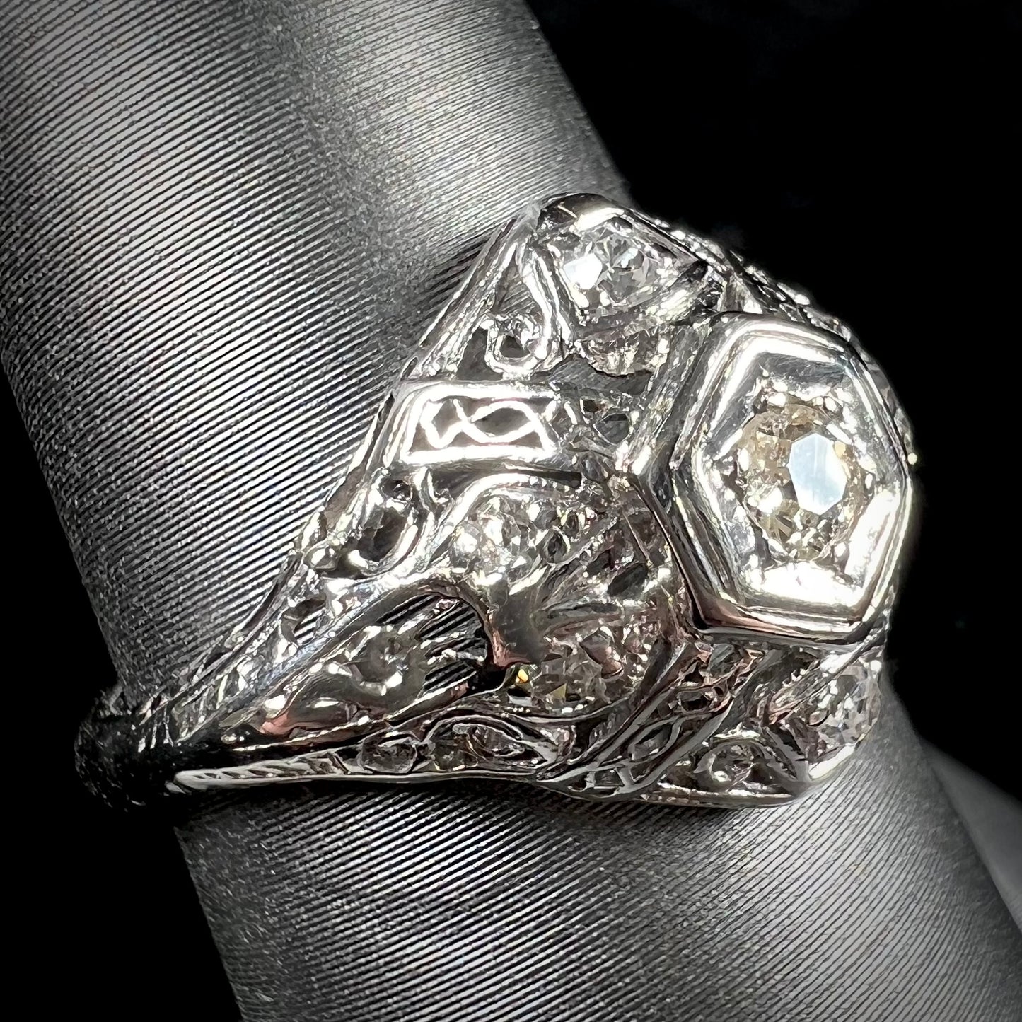 An antique ladies' platinum diamond filigree engagement ring.  The center stone is an old European cut diamond.