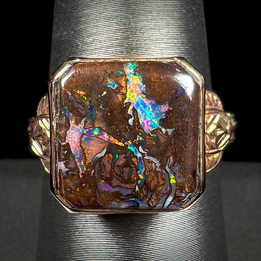 An antique yellow gold boulder opal ring.  The stone is a sqaure cut natural opal from Quilpie, Australia.