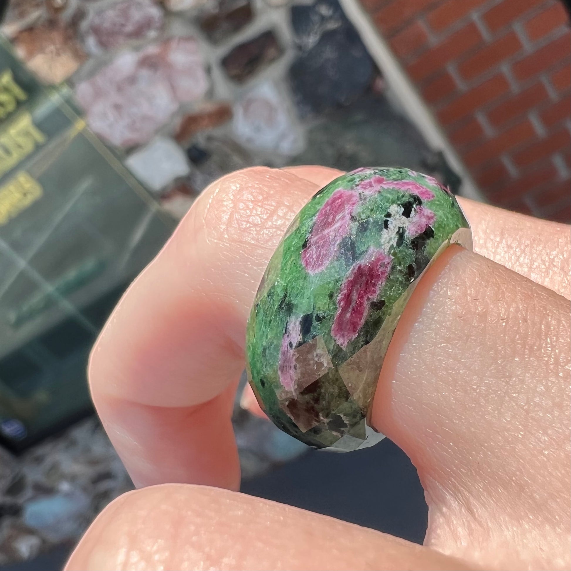 A faceted, carved stone ring made form ruby in zoisite.