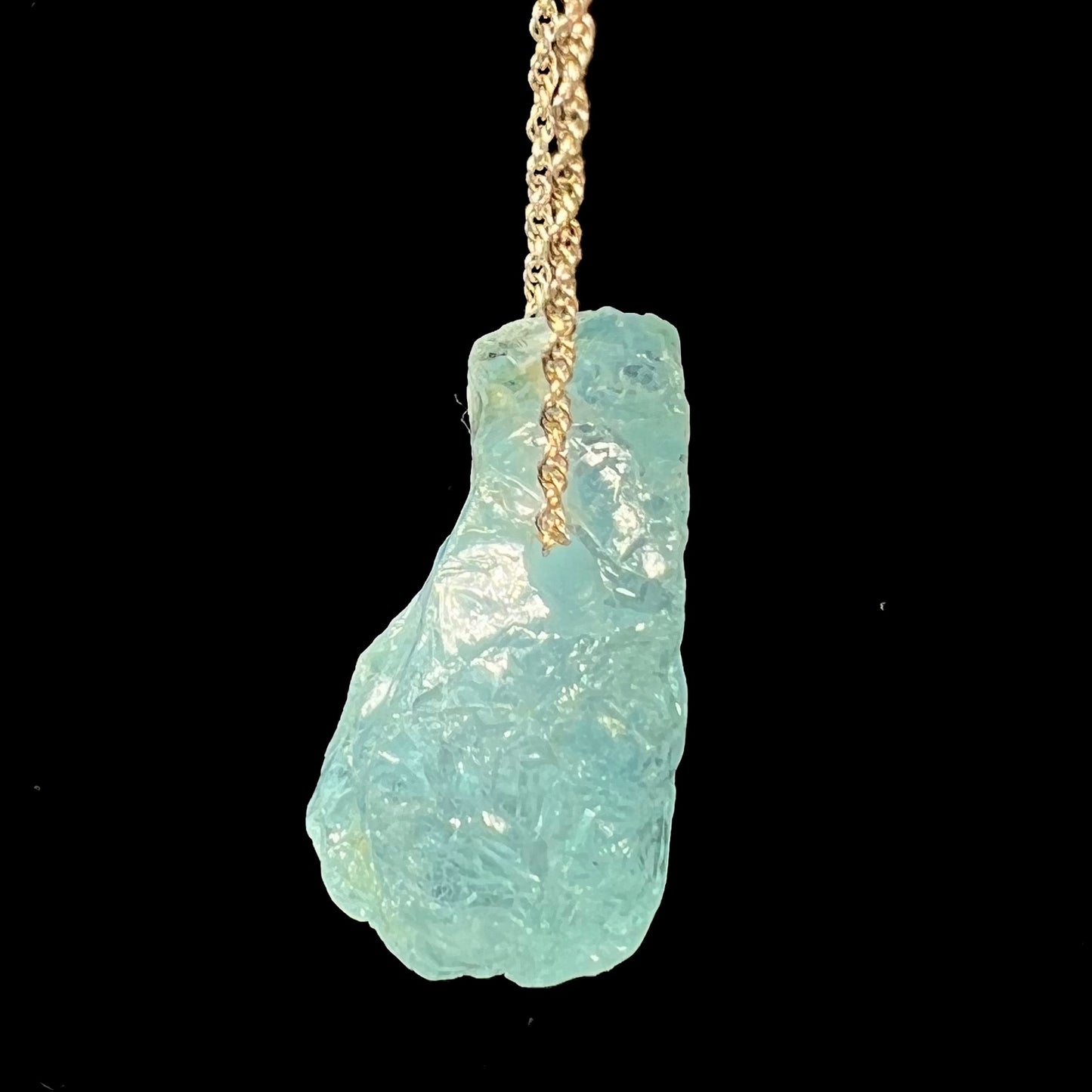 A drilled aquamarine crystal necklace on a silver wheat chain.