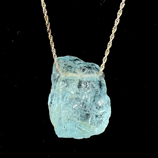 A drilled aquamarine crystal necklace on a silver wheat chain.