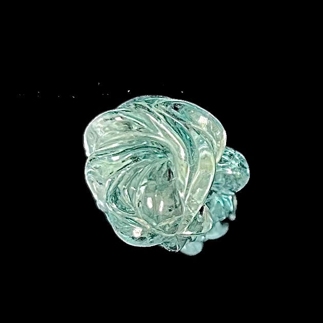 A stone woman figure carved from a blue aquamarine crystal.  The piece resembles Venus Gummi de Milo.