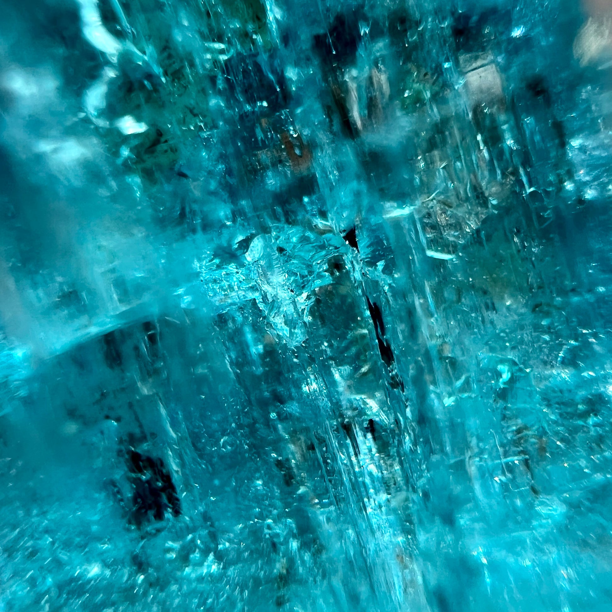 The inside inclusions of a natural blue aquamarine crystal from Vietnam.