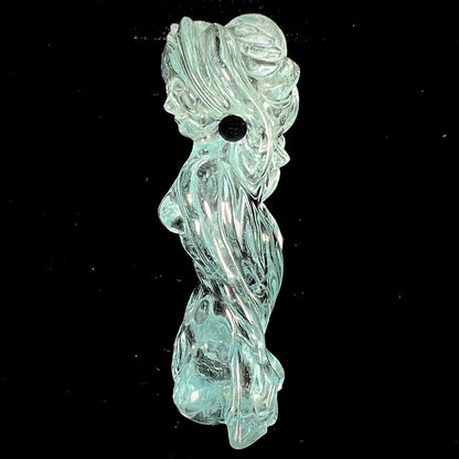 A stone woman figure carved from a blue aquamarine crystal.  The piece resembles Venus Gummi de Milo.