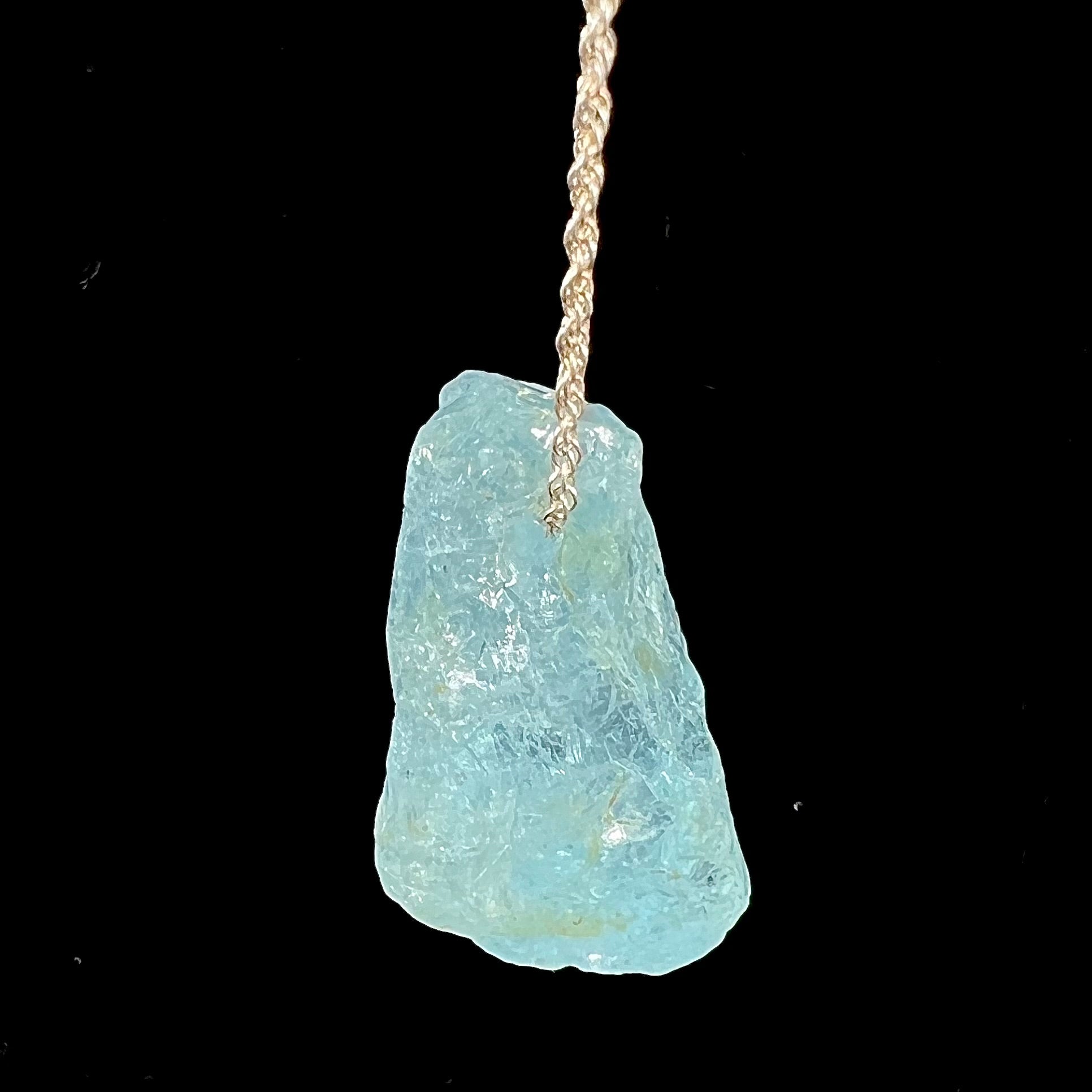 A drilled aquamarine crystal necklace on a silver wheat chain.