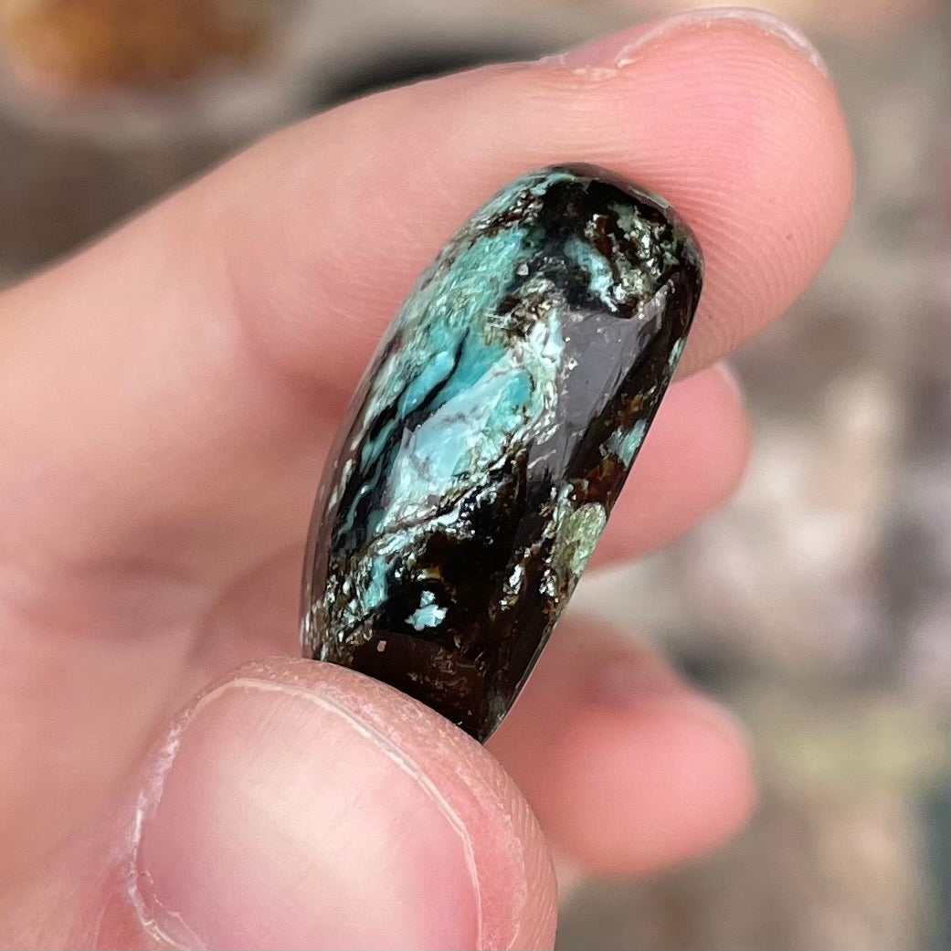 A loose, oval cabochon cut Royston turquoise stone from Nevada.