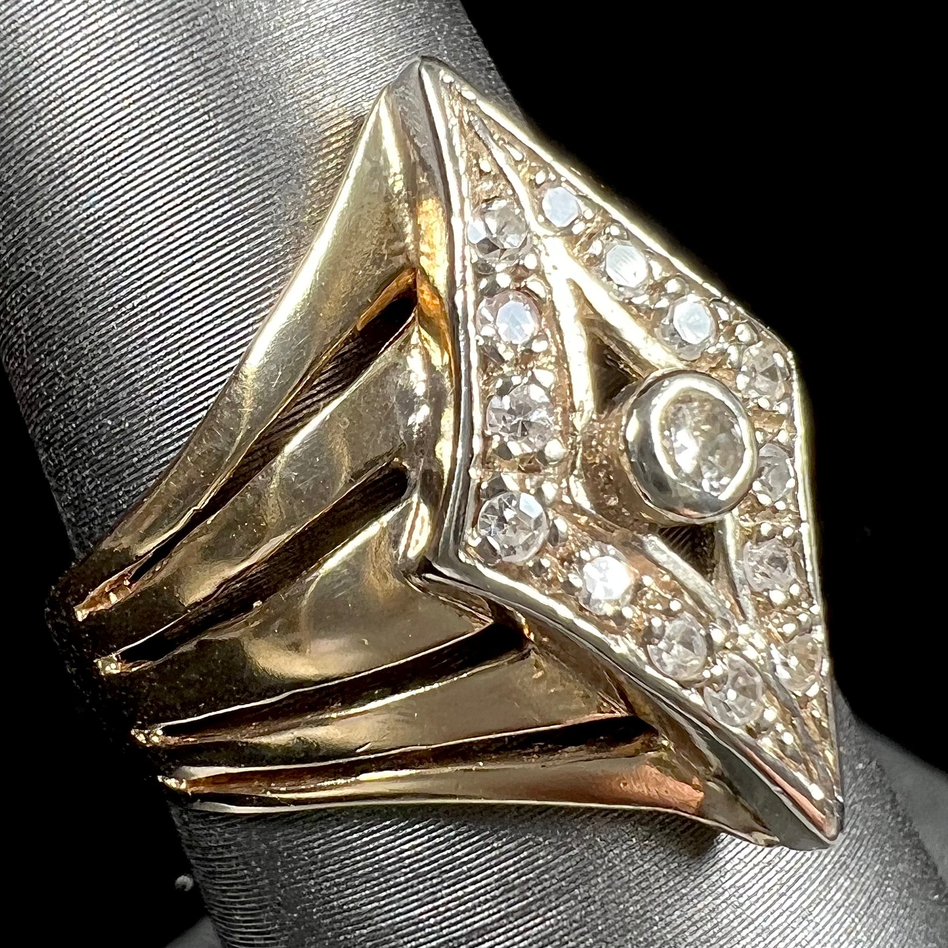 An estate ladies' gold diamond ring.  The shape of the ring resembles an art deco style diamond.