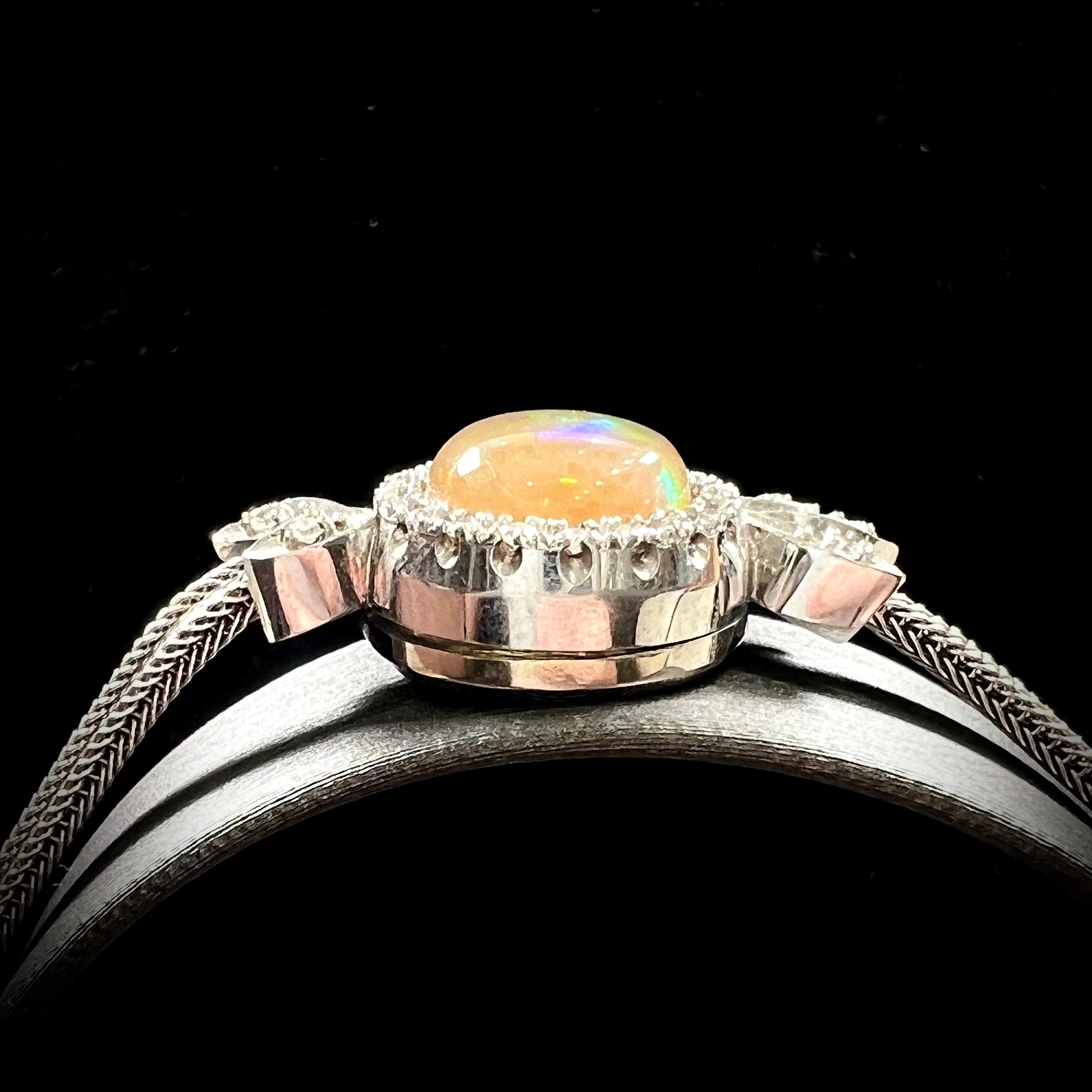 A Virgin Valley fire opal and diamond bracelet made from a vintage 1930's watch.