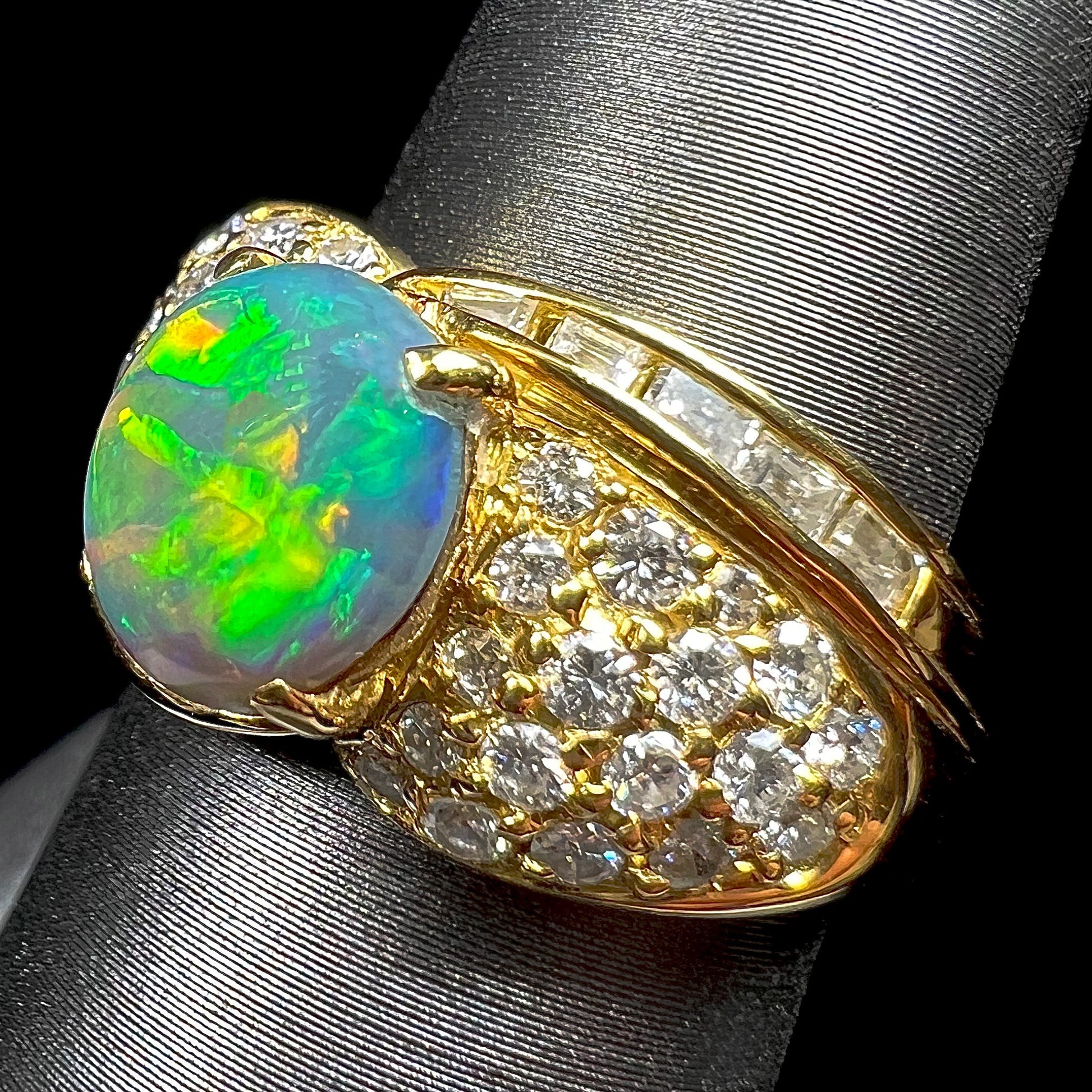 A natural, Australian black opal and diamond ring cast in 18 karat yellow gold..