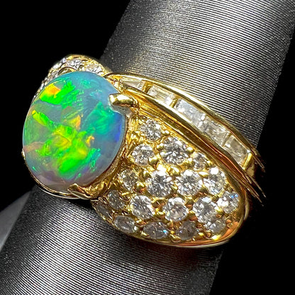 A natural, Australian black opal and diamond ring cast in 18 karat yellow gold..