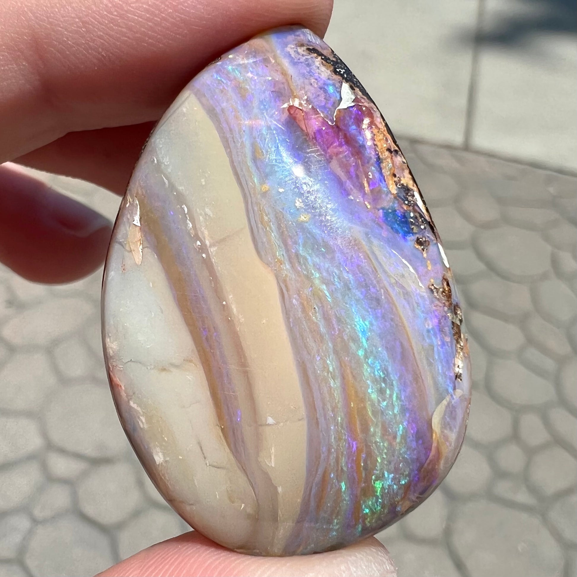 A loose, drop shaped Australian boulder opal from Quilpie Mining District.