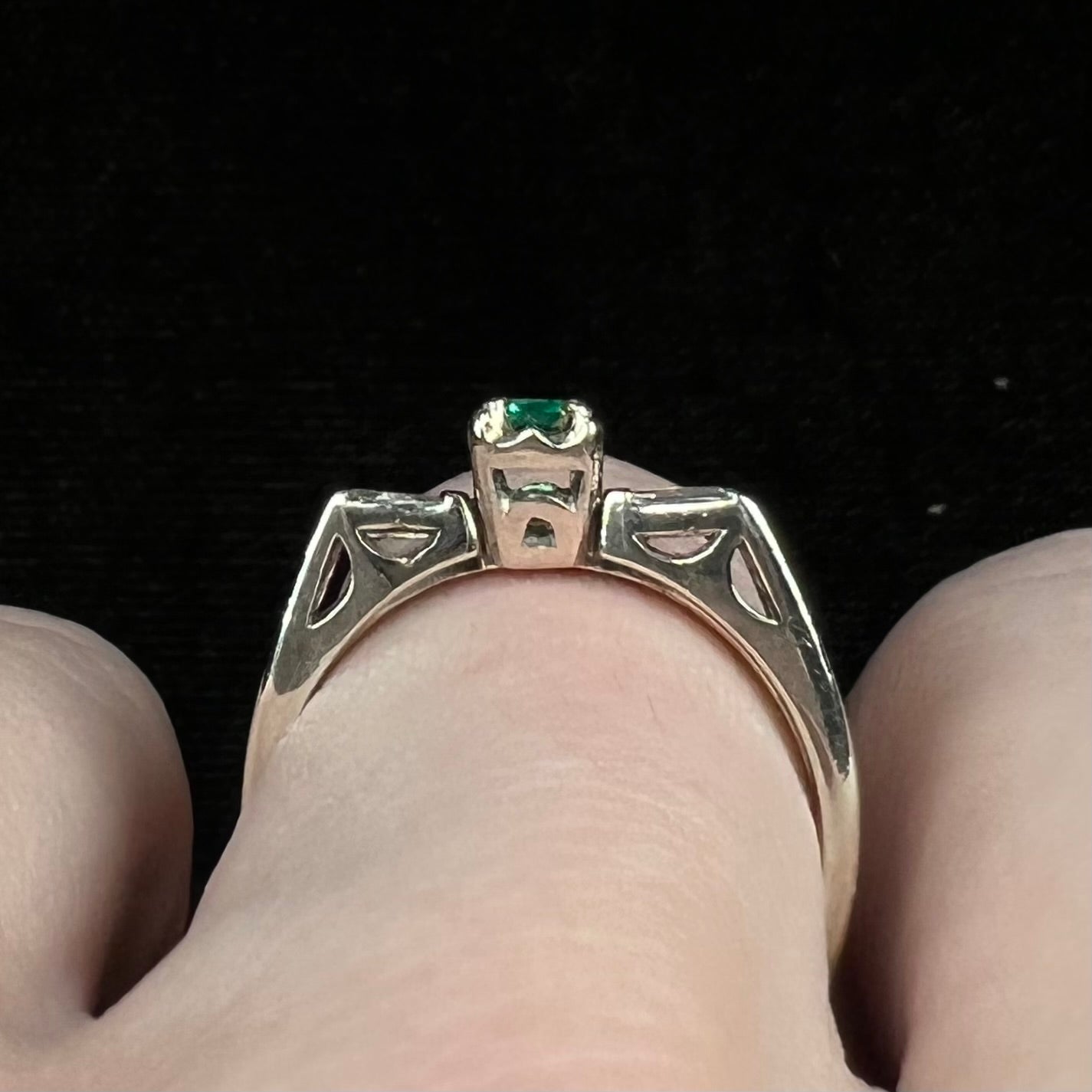 A white gold emerald and baguette cut diamond engagement and wedding set.