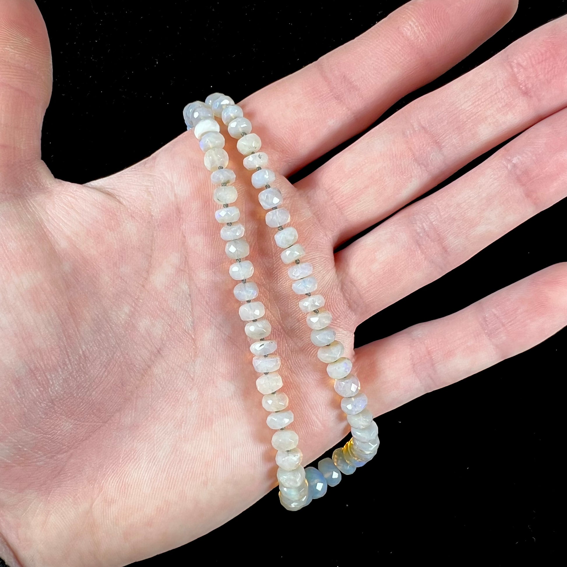 A necklace strand of faceted white crystal opal beads with a white gold clasp.